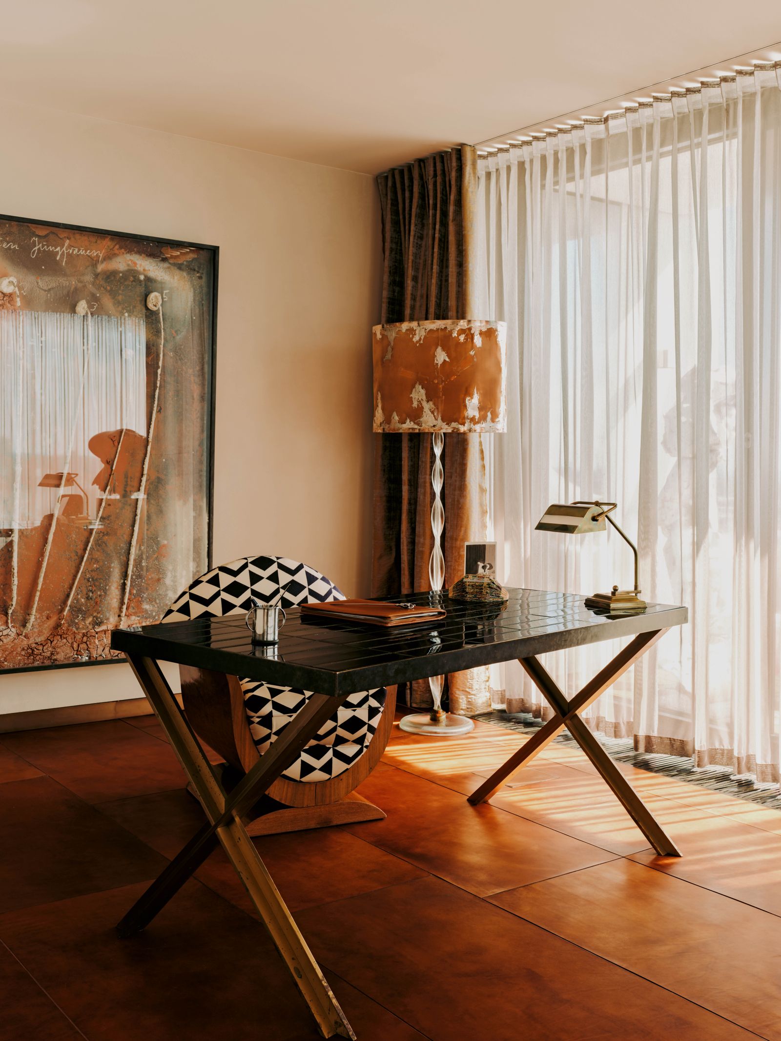 Am Schreibtisch steht ein grafisch gemusterter Sessel